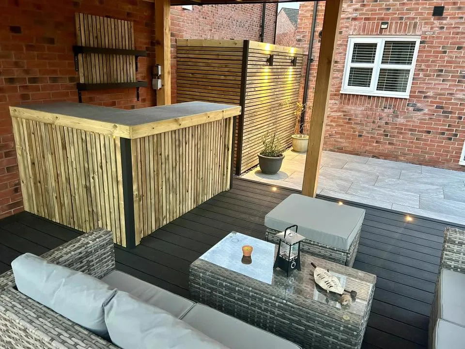 Timber outdoor bar beneath a handcrafted gazebo with slatted screen backdrop