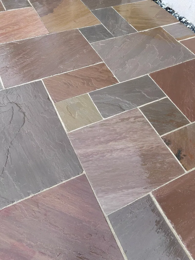 Riven Indian sandstone paving in warm autumn tones